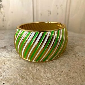 Gold green and white coloured metal hinged bangle style bracelet